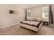 Comfortable bedroom with a patterned blanket and ample natural light at 17320 W Daley Ln, Surprise, AZ 85387
