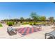 Outdoor game area with checkerboard surface and seating, ideal for recreation at 17320 W Daley Ln, Surprise, AZ 85387