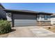 Attached two-car garage featuring stone veneer accents on a well-maintained single-Gathering home at 17320 W Daley Ln, Surprise, AZ 85387