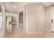 Inviting hallway with neutral tones and tiled flooring, leading to various rooms in the home at 17320 W Daley Ln, Surprise, AZ 85387