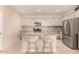 Well-appointed kitchen with stainless steel appliances, granite countertops, and island seating at 17320 W Daley Ln, Surprise, AZ 85387