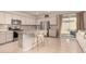 Modern kitchen featuring a center island with barstool seating and stainless steel appliances at 17320 W Daley Ln, Surprise, AZ 85387