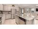 Open-concept kitchen with island, stainless steel appliances, and a view of the living space at 17320 W Daley Ln, Surprise, AZ 85387
