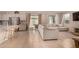 Bright living room featuring tile floors, neutral furniture, and sliding glass door at 17320 W Daley Ln, Surprise, AZ 85387