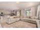 Open-concept living area with comfortable seating, tile floors, and natural light at 17320 W Daley Ln, Surprise, AZ 85387