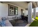 Inviting covered patio area with outdoor seating and a view of the backyard at 17320 W Daley Ln, Surprise, AZ 85387