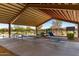 The picnic area features outdoor seating beneath a shaded roof structure with views of the community playground at 17320 W Daley Ln, Surprise, AZ 85387