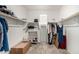Spacious walk-in closet with shelving and ample storage space for organizing clothes and personal belongings at 17320 W Daley Ln, Surprise, AZ 85387