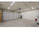 Spacious garage with an automatic door and ample lighting, offering plenty of room for vehicles and storage at 1744 W Brookwood Ct, Phoenix, AZ 85045