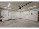 Brightly lit garage, featuring shelving and a water heater at 1744 W Brookwood Ct, Phoenix, AZ 85045