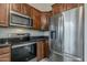 Modern kitchen featuring stainless steel appliances, dark granite countertops, and ample cabinetry at 1744 W Brookwood Ct, Phoenix, AZ 85045