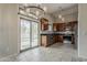 Modern kitchen with stainless steel appliances, dark granite countertops, and a sliding glass door at 1744 W Brookwood Ct, Phoenix, AZ 85045