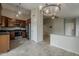 Open-concept kitchen with stainless steel appliances, dark wood cabinets, and tile flooring at 1744 W Brookwood Ct, Phoenix, AZ 85045