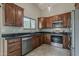 Modern kitchen with stainless steel appliances, dark granite countertops, and abundant cabinet space at 1744 W Brookwood Ct, Phoenix, AZ 85045