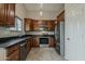Modern kitchen with stainless steel appliances, dark granite countertops, and abundant cabinet space at 1744 W Brookwood Ct, Phoenix, AZ 85045