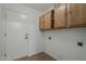 Laundry room featuring overhead storage cabinets and tile flooring at 1744 W Brookwood Ct, Phoenix, AZ 85045