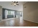 An open-concept living space with tile flooring, neutral walls, and an abundance of natural light at 1744 W Brookwood Ct, Phoenix, AZ 85045
