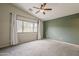 The primary bedroom boasts a neutral color palette and natural light with carpeting and ceiling fan at 1744 W Brookwood Ct, Phoenix, AZ 85045