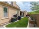 Well-manicured backyard featuring artificial turf, desert landscaping, and outdoor grilling area at 18550 N 94Th St, Scottsdale, AZ 85255