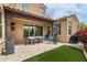 A covered outdoor dining area is the highlight of this backyard oasis with turf at 18550 N 94Th St, Scottsdale, AZ 85255