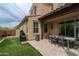 Exterior view of backyard with artificial turf, patio, and outdoor kitchen area at 18550 N 94Th St, Scottsdale, AZ 85255