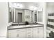 Bathroom featuring a dual sink vanity, large mirrors, modern lighting, and a shower with a curtain at 18550 N 94Th St, Scottsdale, AZ 85255