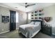 A charming bedroom with sporty accents, a ceiling fan, gray walls, and natural light from the windows at 18550 N 94Th St, Scottsdale, AZ 85255