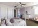 Bedroom featuring a plush white bed, large closet, vanity with a mirror, and light purple walls at 18550 N 94Th St, Scottsdale, AZ 85255
