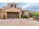 Two-story home with neutral paint, a two-car garage, and desert landscaping at 18550 N 94Th St, Scottsdale, AZ 85255