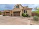 Beautiful townhome featuring an attached garage, desert landscaping, and a paved driveway at 18550 N 94Th St, Scottsdale, AZ 85255