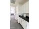 Hallway features grey carpet flooring, white cabinets with a black countertop, and a view into the bedroom at 18550 N 94Th St, Scottsdale, AZ 85255