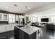 Open kitchen flows into living area, featuring large island with sink and stainless steel appliances at 18550 N 94Th St, Scottsdale, AZ 85255