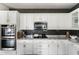 The kitchen showcases stainless appliances, granite countertops, and modern cabinetry at 18550 N 94Th St, Scottsdale, AZ 85255
