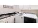 Well-lit laundry room with modern washer and dryer, ample countertop space, and storage cabinets at 18550 N 94Th St, Scottsdale, AZ 85255