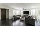 Bright living room with hardwood floors, neutral-toned sofas, ceiling fan, and abundant natural light at 18550 N 94Th St, Scottsdale, AZ 85255