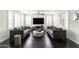 Open-concept living room with hardwood floors, neutral-toned sofas, and large windows with shutters at 18550 N 94Th St, Scottsdale, AZ 85255