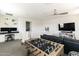 Spacious living area with a foosball table, TV, and desk, ideal for both entertainment and work at 18550 N 94Th St, Scottsdale, AZ 85255