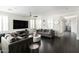Spacious living room featuring hardwood floors, a modern ceiling fan, and an open layout at 18550 N 94Th St, Scottsdale, AZ 85255