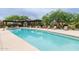 Refreshing community pool with lounge chairs and covered pergola seating area, perfect for relaxation and enjoyment at 18550 N 94Th St, Scottsdale, AZ 85255