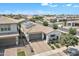Drone shot of a beautiful home featuring desert landscaping, two car garage and covered porch at 1876 S Huish Dr, Gilbert, AZ 85295
