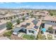 Beautiful aerial view of a home with solar panels, outdoor kitchen, and private pool at 1876 S Huish Dr, Gilbert, AZ 85295