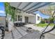 Beautiful patio features a built-in grill, modern furniture and a pergola at 1876 S Huish Dr, Gilbert, AZ 85295