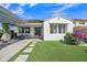 Charming backyard featuring a pergola covered patio, artificial grass, and lush landscaping at 1876 S Huish Dr, Gilbert, AZ 85295