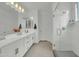 Bright bathroom featuring double sinks, a vanity, and a walk-in shower at 1876 S Huish Dr, Gilbert, AZ 85295