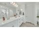 Bright bathroom featuring double sinks, a vanity, and a walk-in shower at 1876 S Huish Dr, Gilbert, AZ 85295