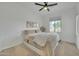 Neutral bedroom with large window, a ceiling fan, and layered wall art at 1876 S Huish Dr, Gilbert, AZ 85295
