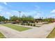 Bocce ball court in a community space with benches, mature trees, and landscaped gardens at 1876 S Huish Dr, Gilbert, AZ 85295
