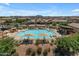 Community pool surrounded by seating areas and meticulously maintained desert landscaping at 1876 S Huish Dr, Gilbert, AZ 85295