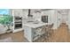 Modern kitchen with white cabinets, stainless steel appliances, quartz countertops, and center island with seating at 1876 S Huish Dr, Gilbert, AZ 85295