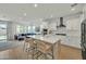 Open-concept kitchen flowing into the living room, featuring an island with seating, and lots of natural light at 1876 S Huish Dr, Gilbert, AZ 85295